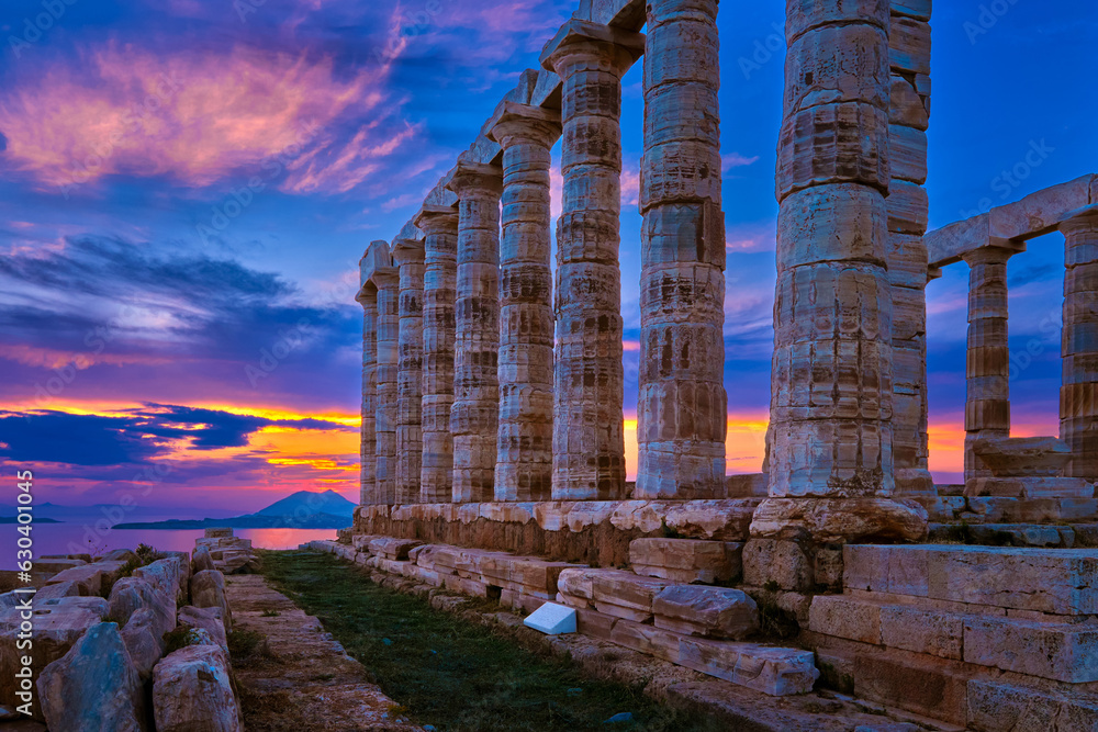 Sunset sky and ancient ruins of temple of Poseidon, Sounion, Greece