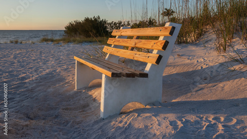 bench on the beach at sunset