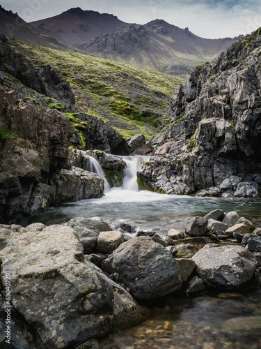 Vertical shot of a picturesque rocky waterfall in the East Fjords, Iceland