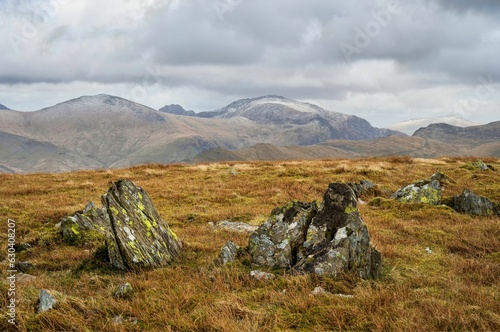 landscape with large boulders in the foreground in the Moel Eilio summit plateau across to Yr Wyddfa photo