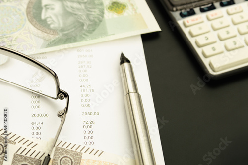 Money and receipts on the table, glasses with business papers