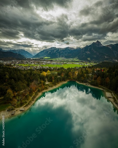 Fototapeta Naklejka Na Ścianę i Meble -  Stunning view of a tranquil body of water surrounded by lush mountains in Reutte, Austria