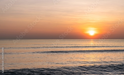 Picturesque beachfront sunset  with bright golden rays of sunlight in thailand
