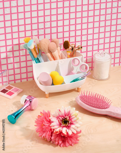 Facial cosmetic products and decorative cosmetic. Makeup products. Pink comb for hair care, scissors for manicure or pedicure, facial brush and facial massagers.