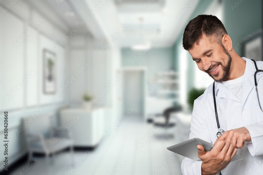 Portrait of happy doctor man holding digital tablet