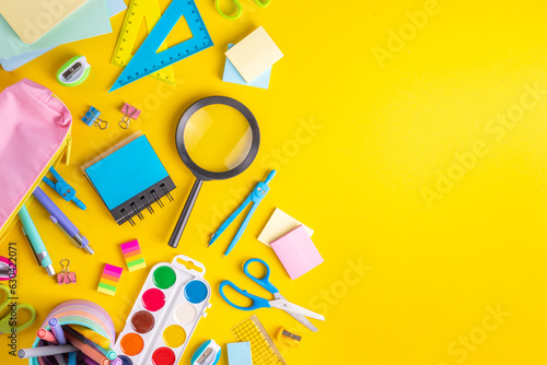 School equipment high-colored bright yellow flat lay. Various school education and office supplies, accessories. Back to school sale background top view copy space