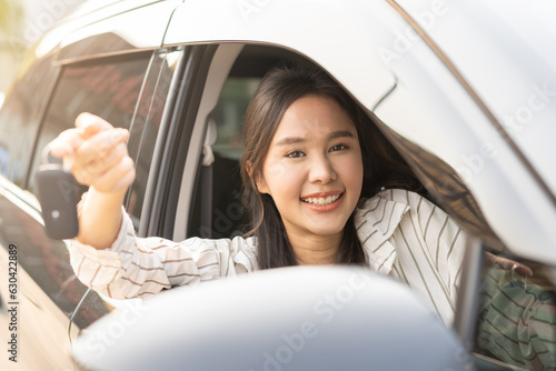 Wallpaper Mural Dealership automobile, smile asian young woman, happy girl sitting in new car after purchase success, showing, holding auto remote key of vehicle, owner driver female buy gift for yourself at showroom Torontodigital.ca