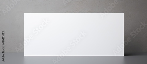 white business card on a grey background with copy space, suitable for business purposes or stationery needs.