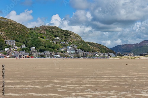 view from the beach on the town at the foot of the mountains  photo