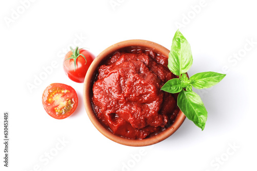 Ripe fresh tomatoes on a white plate, tomato sauce. Cooking ingredient. Fragrant spice green basil. For design. bowl with tomato sauce basil and fresh tomatoes isolated on white background.