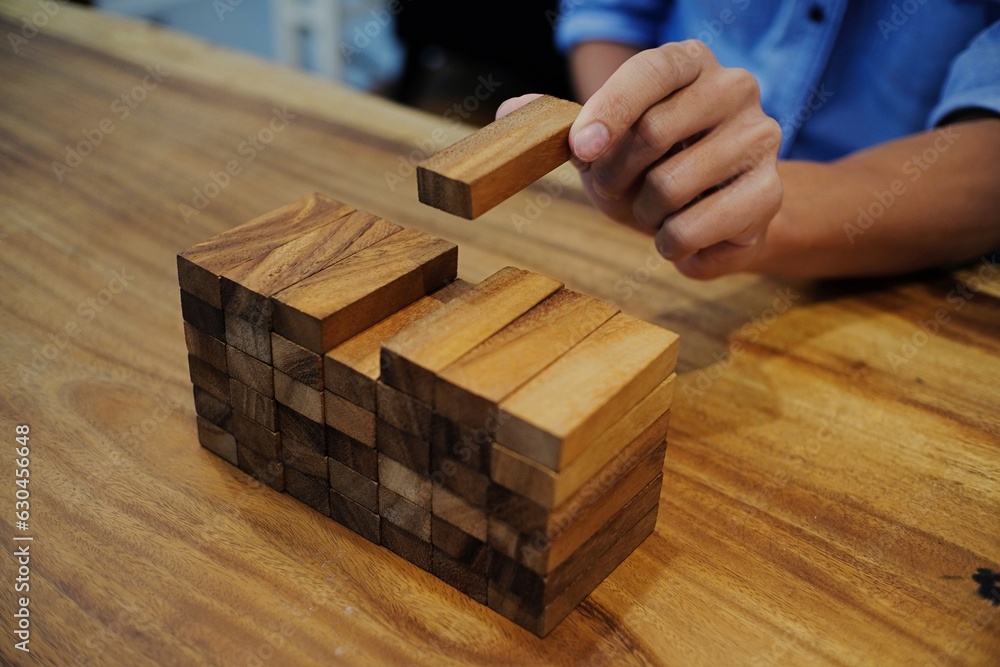 Planning risk and strategy in businessman gambling placing wooden block.Business concept for growth success process Planning risk and strategy in businessman gambling placing wooden block.Business concept for growth success process