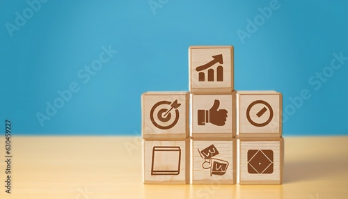 Business strategy, business management or business success concept. Hand arranging wooden blocks with business icon in tower stacked shape.
