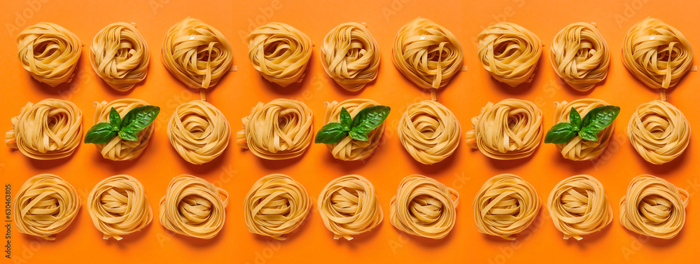 Many dry pasta nests with basil on orange background, top view Many dry pasta nests with basil on orange background, top view