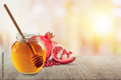 Jewish holiday concept. Fresh Pomegranate and honey