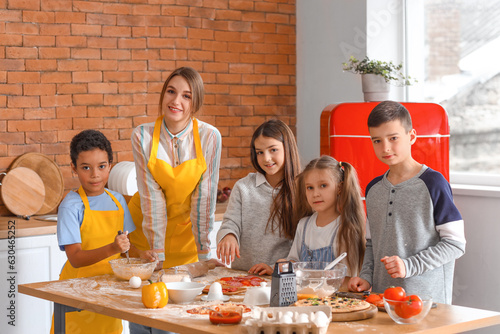 Female chef with group of l...