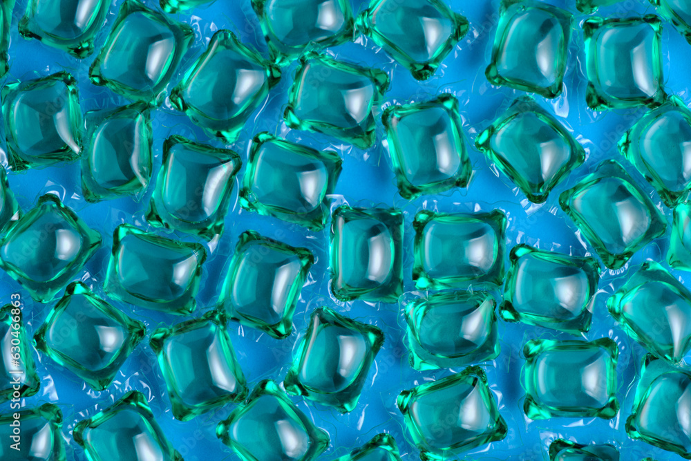 Background lot of capsules for washing green on blue background. Background lot of capsules for washing green on blue background.