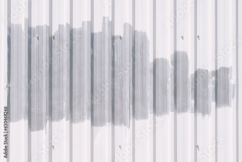 White metal corrugated fence painted with gray paint background