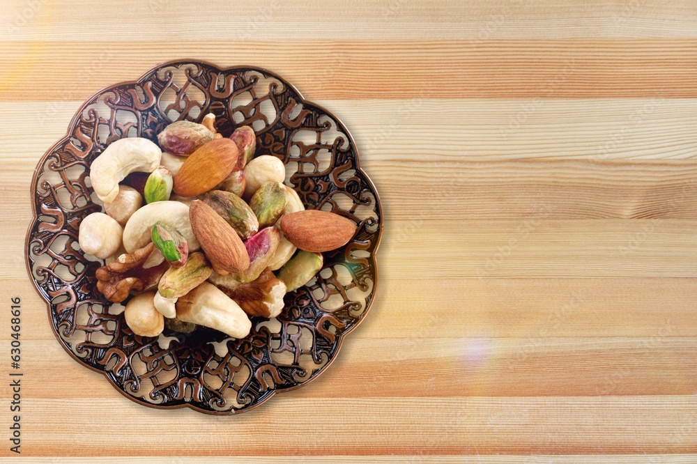 mixed tasty nuts in bowl on the desk mixed tasty nuts in bowl on the desk