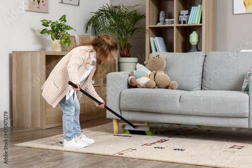 Cute little girl sweeping c...