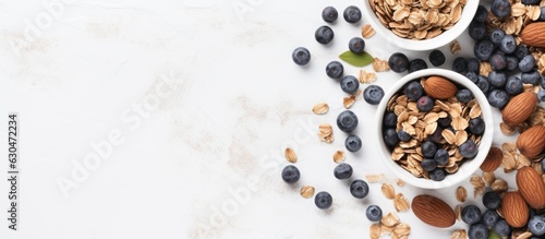 Homemade Granola, Muesli With Pieces Of Dark Chocolate, Nuts And Blueberries In Bowl On White Marble Background. Healthy Breakfast. Top View. Space For Text.