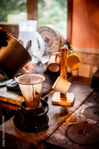A Essência do Campo: Café Sendo Coado à Moda Antiga no Fogão a Lenha photo