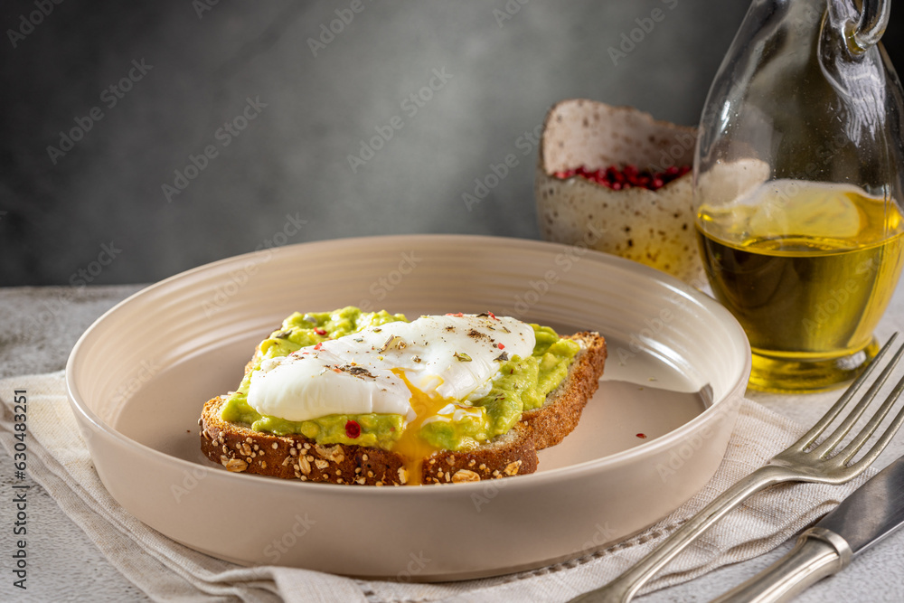 Wholemeal toast with avocado and poached egg. Wholemeal toast with avocado and poached egg.