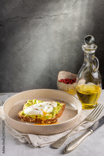 Wholemeal toast with avocado and poached egg. photo