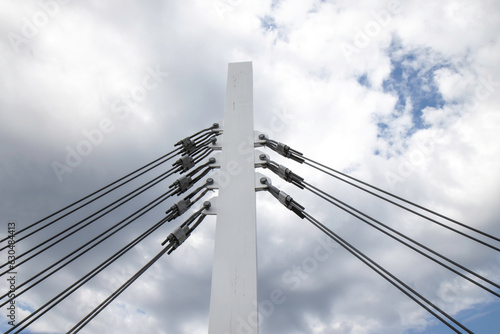 Wallpaper Mural Large rectangular wooden bridge support column fastened by heavy steel braided guy wires and turnbuckles, blue sky with clouds, nobody Torontodigital.ca