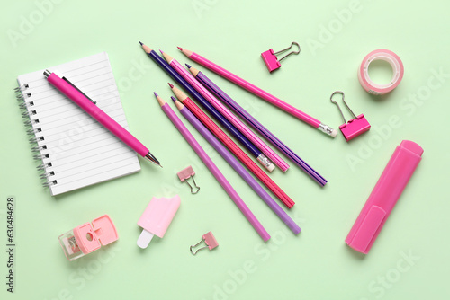 Set of stationery with pencils on color background
