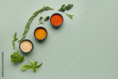 Fototapeta Naklejka Na Ścianę i Meble -  Composition with bowls of fresh spices and herbs on color background