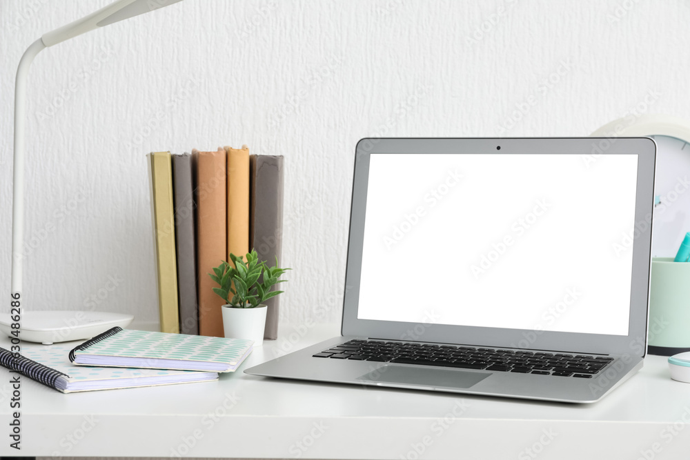 Fototapeta premium remote work and home office productivity, laptop on desk with books and stationery