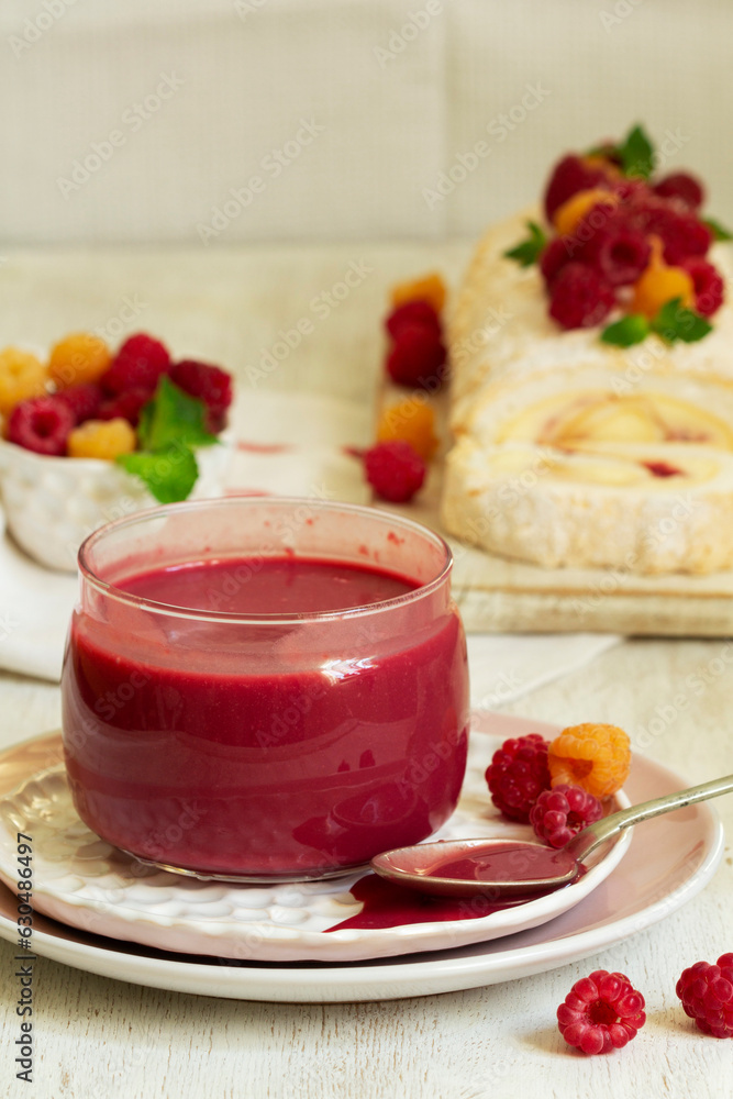 Raspberry curd, raspberries and meringue roll on a light background. Rustic style.