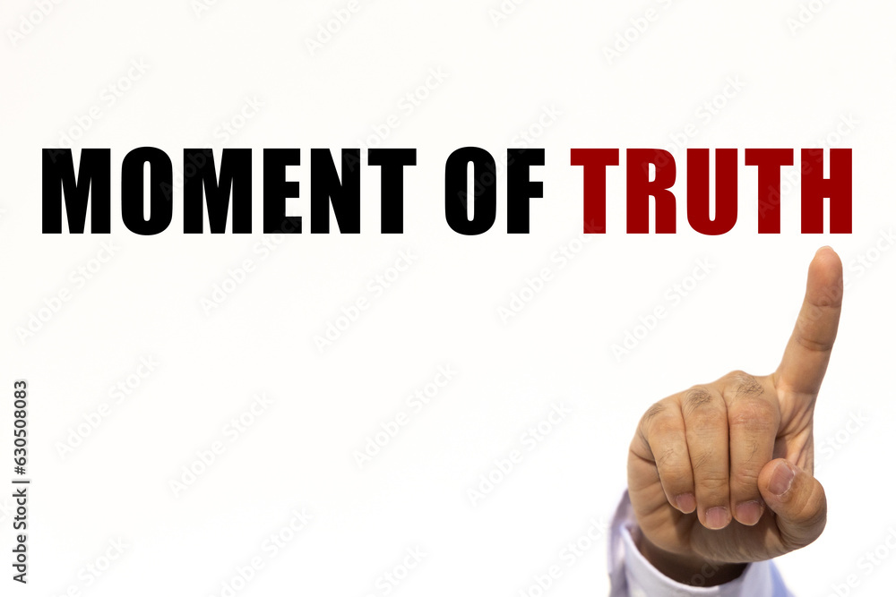 Moment of truth text on white wall background with businessman's finger point at the message with empty space. This message can be used as business concept about moment of truth. Moment of truth text on white wall background with businessman's finger point at the message with empty space. This message can be used as business concept about moment of truth.