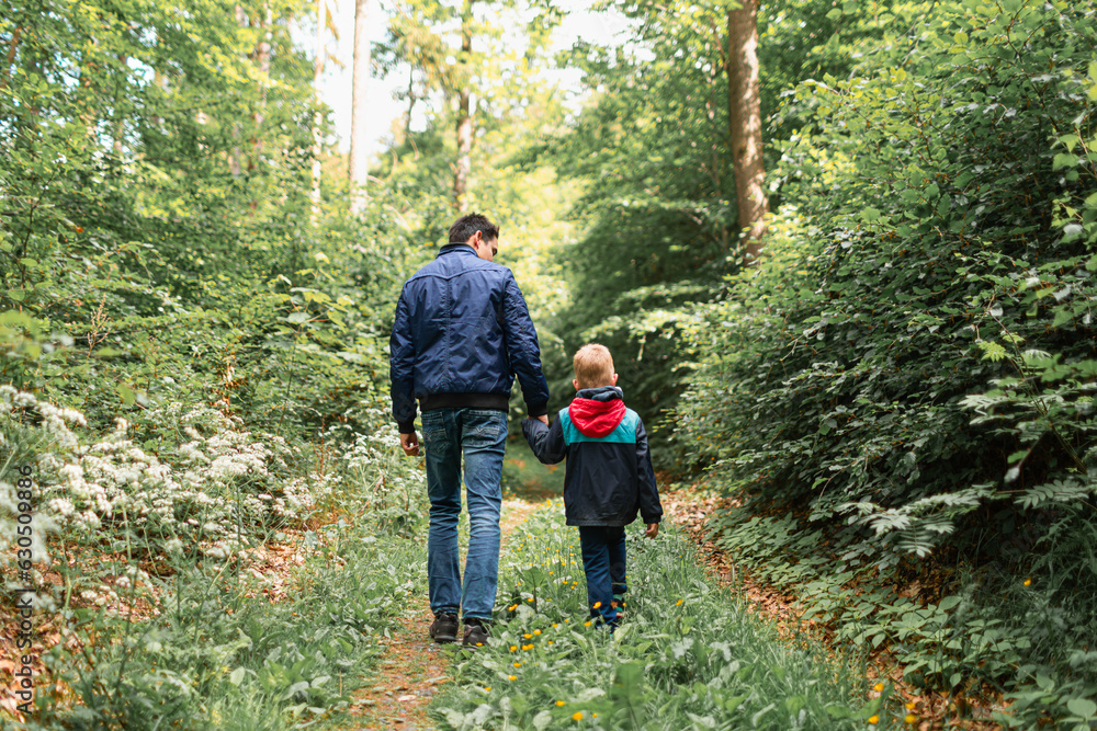 Father and son walking in forest, bonding, love, togetherness. Father and son walking in forest, bonding, love, togetherness.