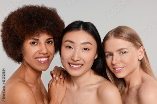 Portrait of beautiful young women on light grey background
