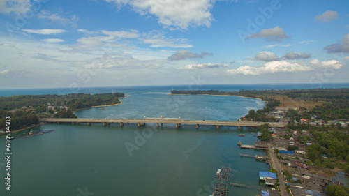 .Aerial view beautiful Sarasin bridge on the blue sea..Sarasin bridge is important route connecting by land..Scene of white cloud in blue sky and green sea..the bridge connect Phuket to Phang Nga.. © Narong Niemhom