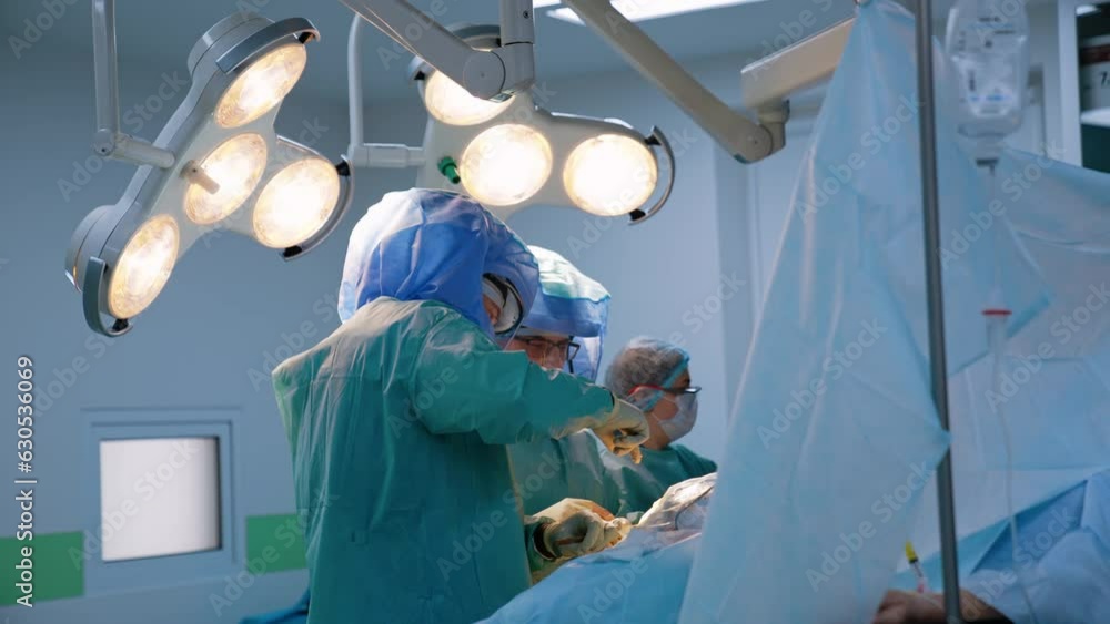 Surgeon orthopedists use metal tool at operation. Modern orthopedic operation for trauma healing. Surgeon orthopedists use metal tool at operation. Modern orthopedic operation for trauma healing.