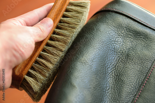 hand with leather brush.