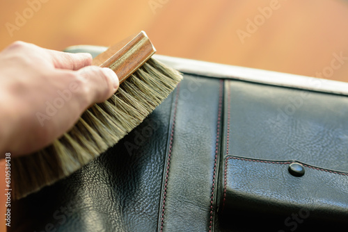 hand with leather brush.