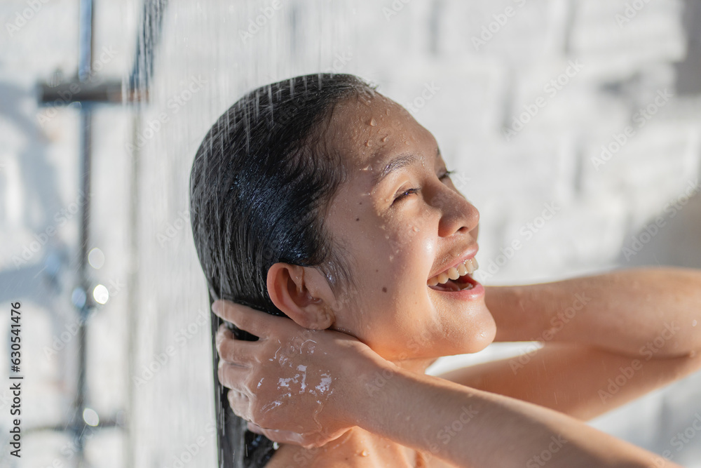 Asian girl having fun while showering She's washed her hair.
