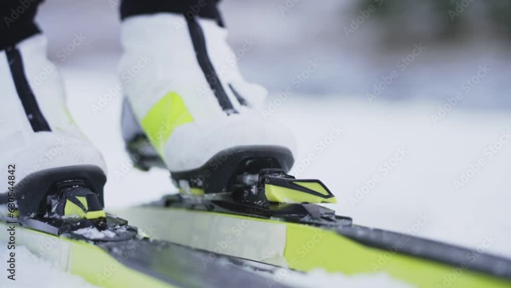 Extreme close up of skiis being locked in. Slow motion shot from the front Extreme close up of skiis being locked in. Slow motion shot from the front