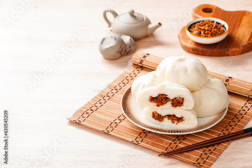 Baozi or Chinese Steamed Buns is a type of yeast-leavened filled bun in various Chinese cuisines. photo