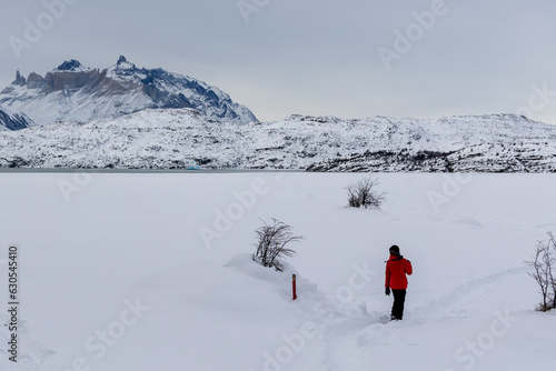 Niño de rojo caminando sobre la nieve photo
