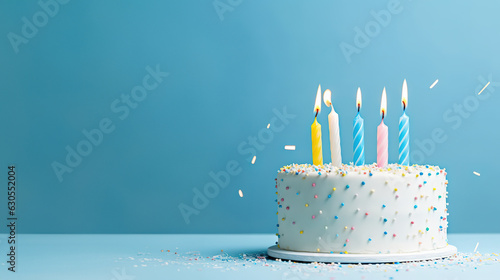birthday cake with 5 (five) candles on pastel blue background with copyspace