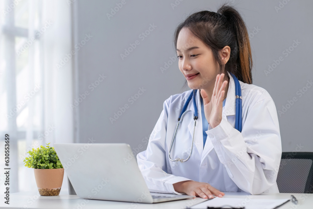 Online video call of doctor with patients. Doctor therapist waving hand in front of laptop, greeting patient Online video call of doctor with patients. Doctor therapist waving hand in front of laptop, greeting patient