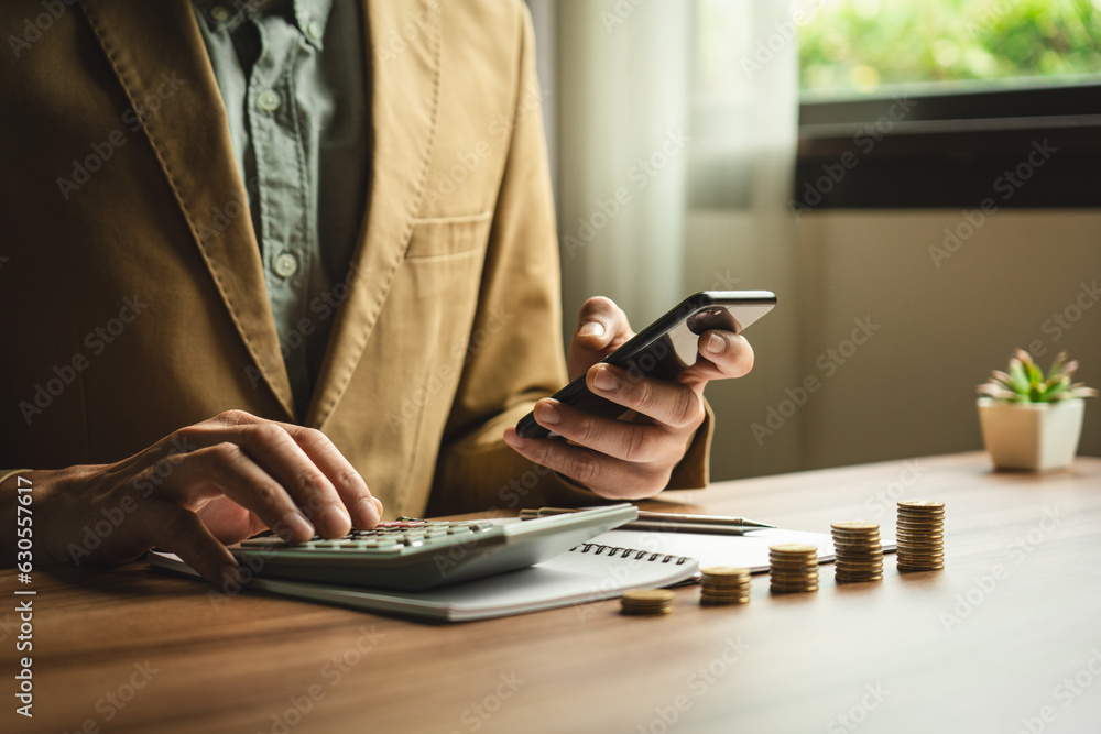 Fototapeta premium Businessman calculates investment income, financial business investments analyze risks, research companies, consult experts, plan wisely for financial goals. insurance companies, mutual funds, stocks