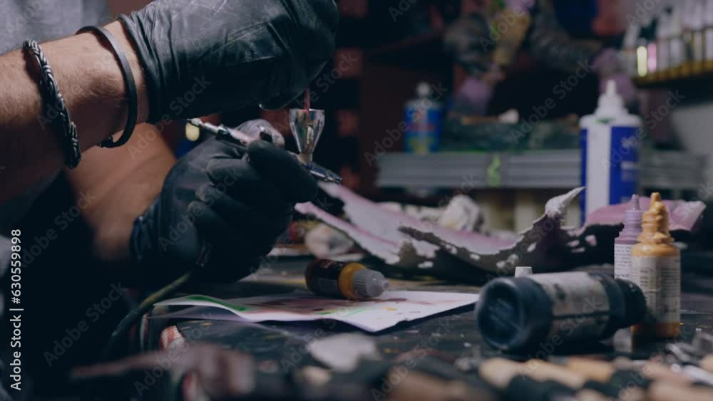 painting workshop man paints mixing paint in airbrush medium slow motion shot painting workshop man paints mixing paint in airbrush medium slow motion shot