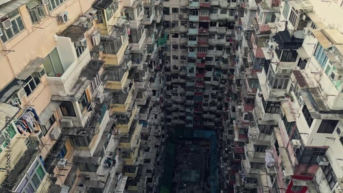 Aerial of an old apartment complex called Yick Fat on Quarry Bay, Hong Kong, China. Known also as Monster Building because it was featured in a Transformers movie. Drone dolly forward shot