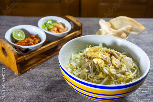 Soto ayam is a typical Indonesian food in the form of a kind of chicken soup with a yellowish sauce.   photo