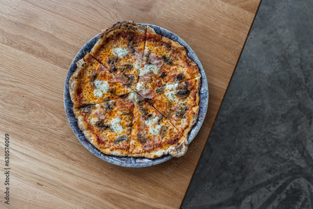 Pizza with minced meat, mushroom and mozzarella cheese on wood table Pizza with minced meat, mushroom and mozzarella cheese on wood table